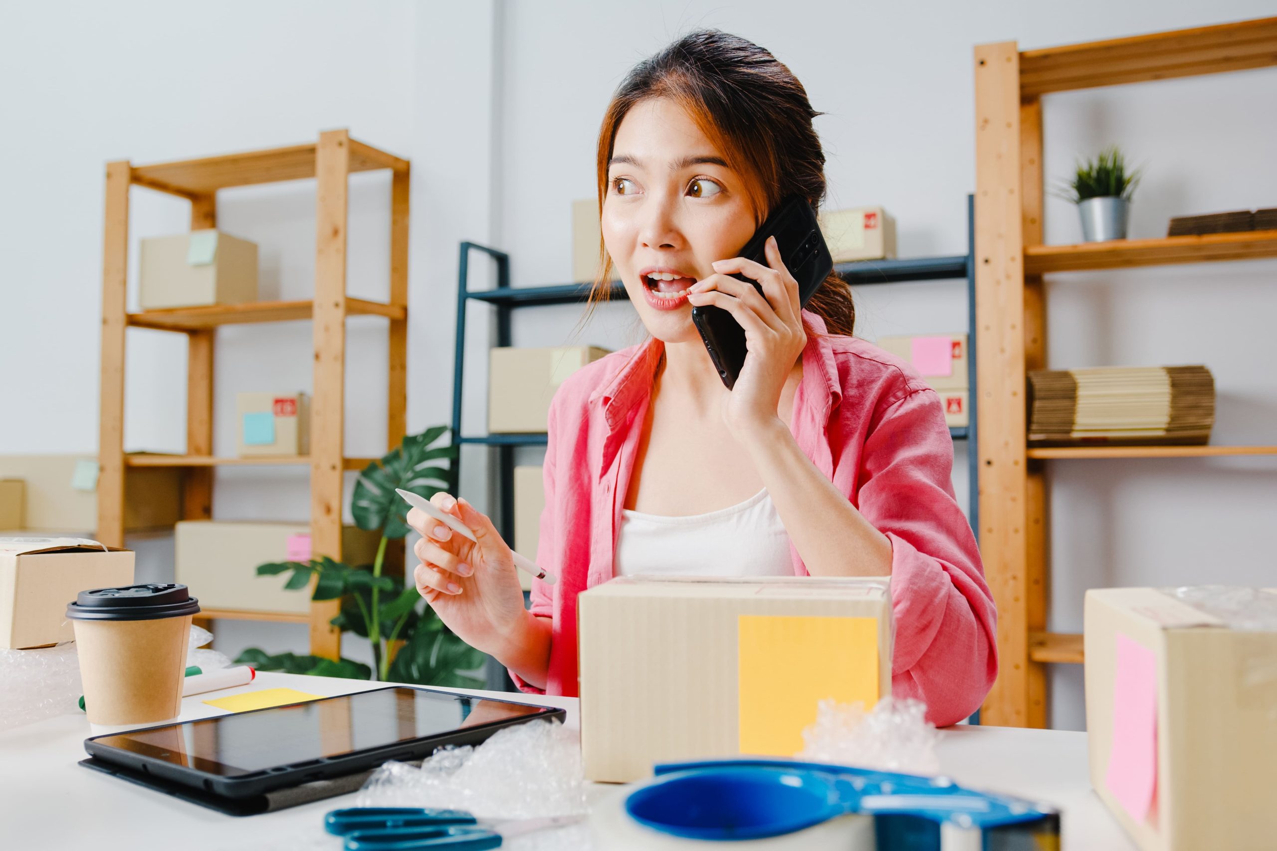 young-asia-businesswoman-using-mobile-phone-call-receiving-purchase-order-check-product-stock-work-home-office-small-business-owner-online-market-delivery-lifestyle-freelance-concept