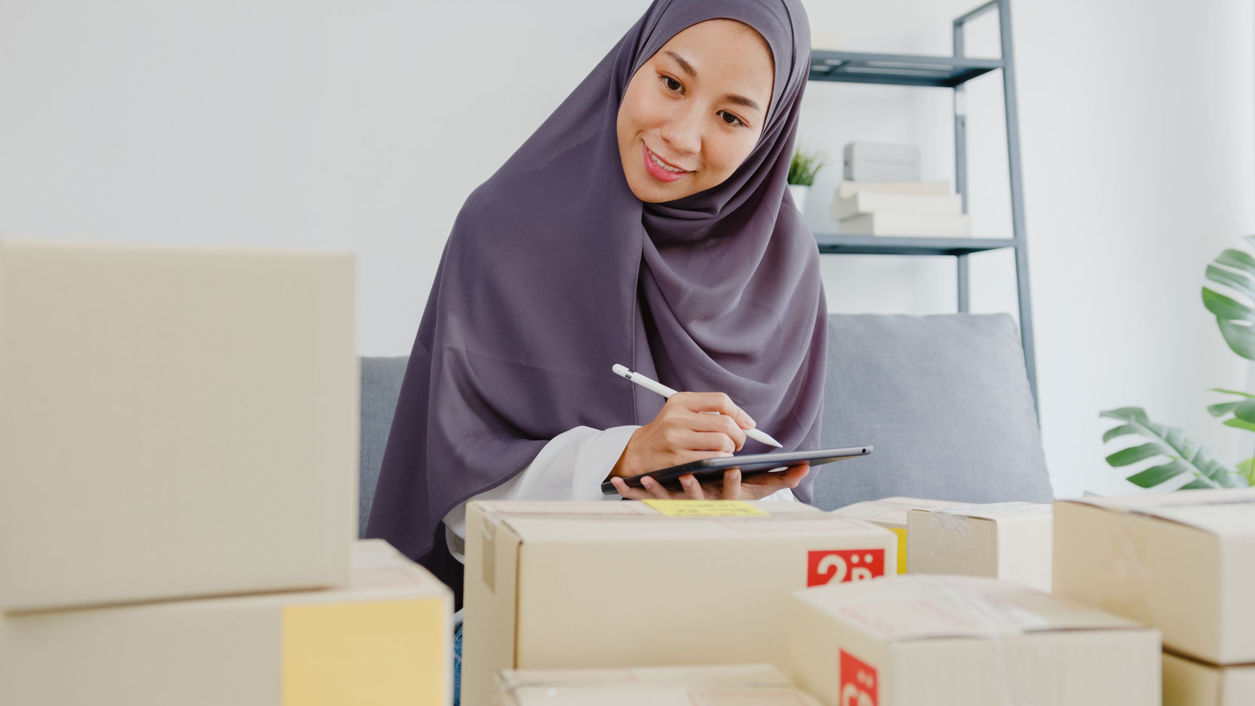 young-muslim-businesswoman-check-product-purchase-order-stock-save-tablet-computer-work-home-office
